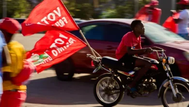 A motorcyclist with flags of the Mozambique Liberation Front (Frelimo) party arrives at a rally in Beira