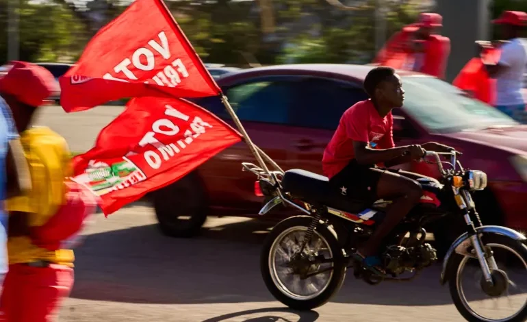 A motorcyclist with flags of the Mozambique Liberation Front (Frelimo) party arrives at a rally in Beira