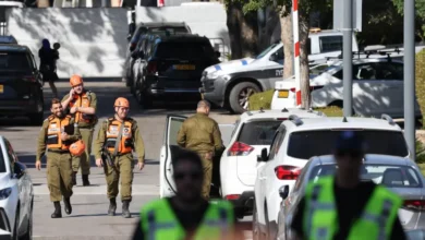 Israeli soldiers walk along a street leading to Prime Minister Benjamin Netanyahu's residence in Caesarea following reports that a drone was launched towards his residence