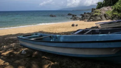 Boats sit on Plage de Moya south of the city of Mutsamudu, the capital of Anjouan in the Comoros Archipelago, one of the main points of departure for refugees