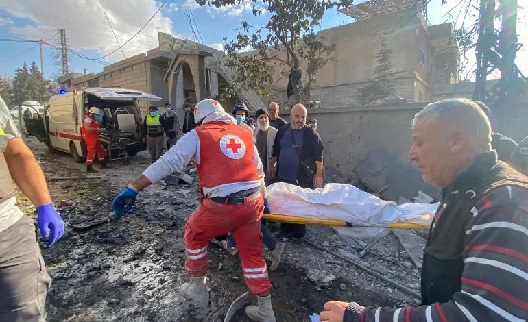 Rescuers carry a body at the site of an Israeli attack in the eastern village of Bazzaliyeh in Bekaa Valley's Hermel district, Lebanon, November 1, 2024