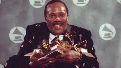 Quincy Jones cradles his Grammy awards, including the album of the year award, for his eclectic album Back on the Block during the 33rd annual Grammy Awards, at New York's Radio City Music Hall night of February 20, 1991