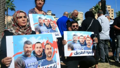 Media workers hold posters bearing the pictures of journalists killed in an Israeli strike in southern Lebanon, at a sit-in in Sidon, on October 26, 2024