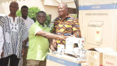 Hon Sam Pyne, Kumasi Mayor presenting some of the items to the PWDs at the ceremony