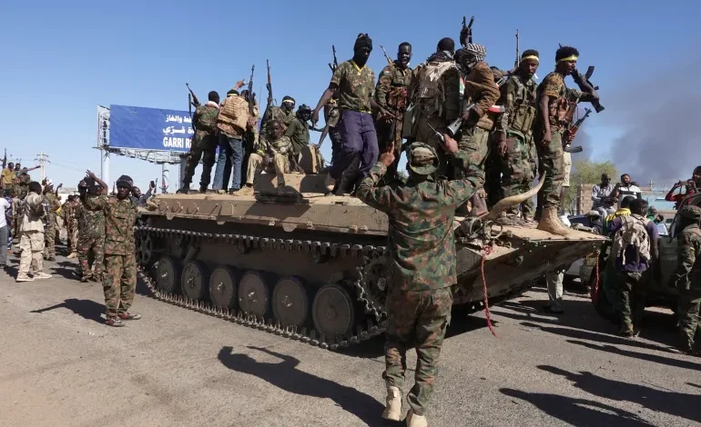 Sudanese army soldiers celebrate after retaking an oil refinery in Khartoum North on January 25, 2025 [El Tayeb Siddig/Reuters]