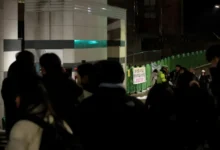 People gather outside an elementary school building in Daejeon where a teacher stabbed an student to death on February 10, 2025