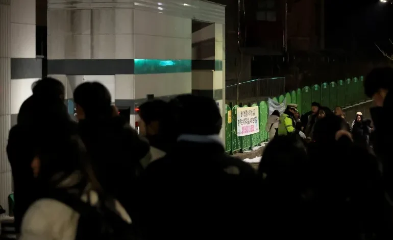 People gather outside an elementary school building in Daejeon where a teacher stabbed an student to death on February 10, 2025