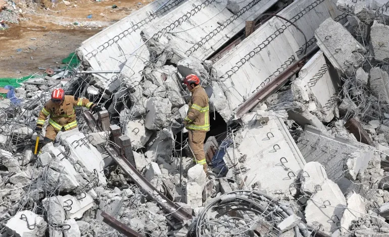 Rescuers search for missing workers after a bridge collapsed in Anseong, South Korea [Yonhap/AFP]